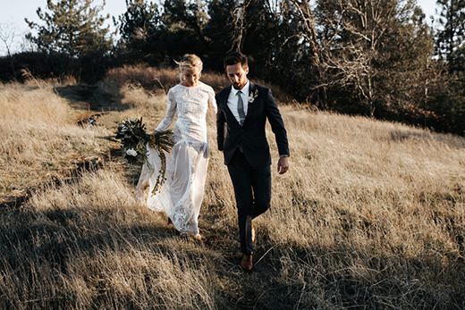 Bride and groom walking the fields at Sacred Mountain